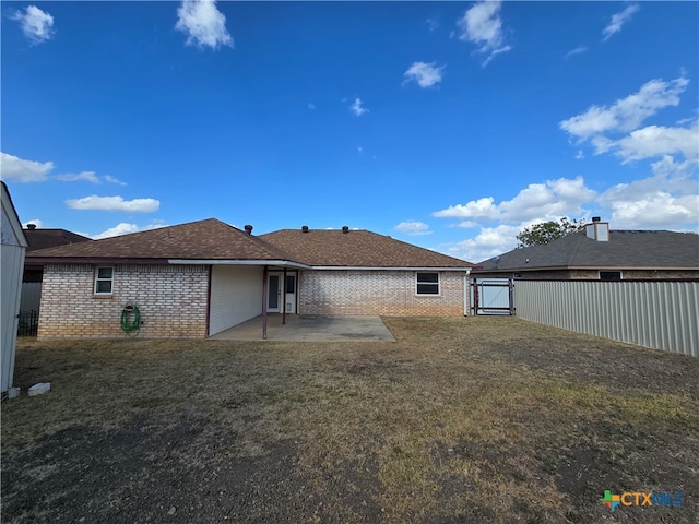 rear view of house with a patio area and a yard