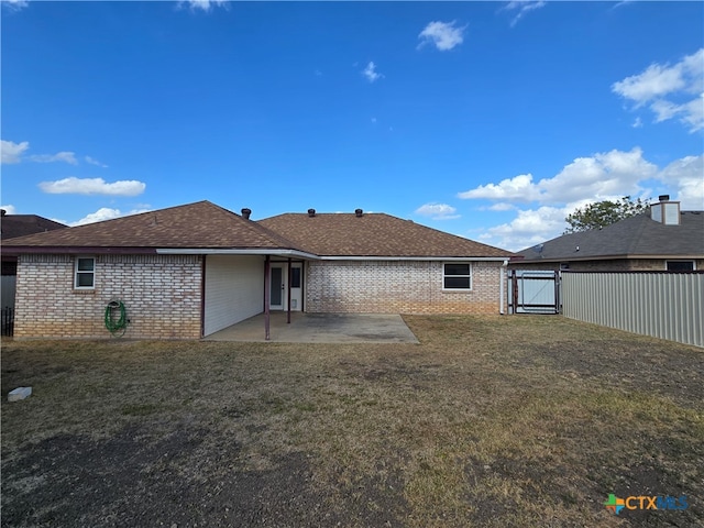 back of property featuring a lawn and a patio area