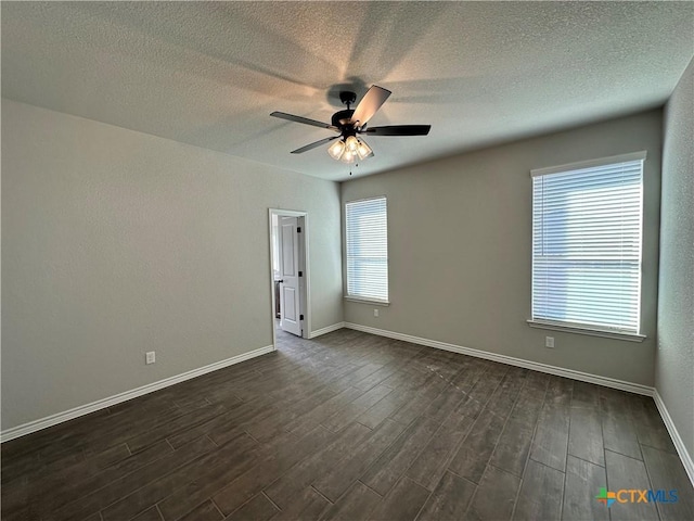 empty room featuring ceiling fan and dark hardwood / wood-style floors