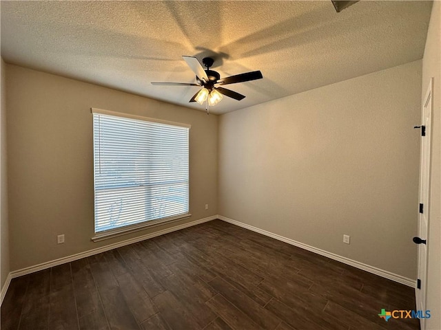 empty room featuring a textured ceiling, ceiling fan, and dark wood-type flooring