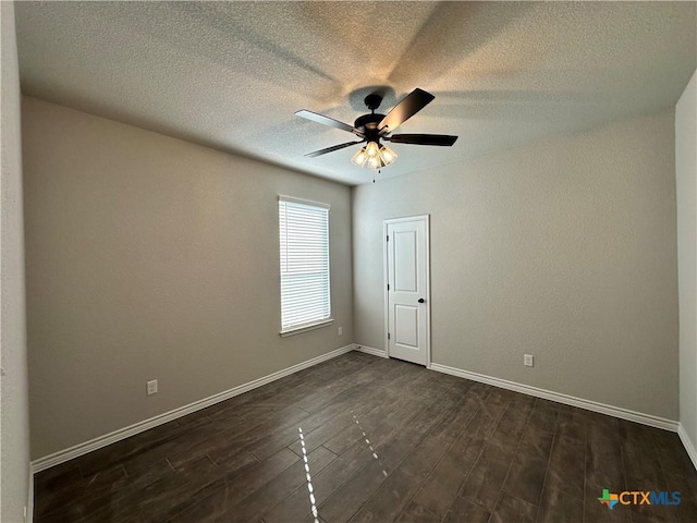 spare room with ceiling fan and dark wood-type flooring