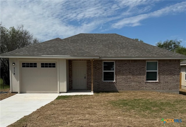 ranch-style home featuring a garage and a front lawn