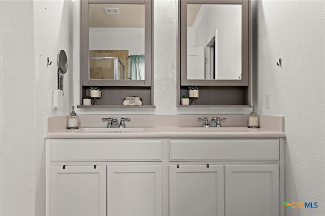 3700 Joyce Ln, Killeen, TX 76549 - bathroom with double vanity, a textured wall, and a tile shower