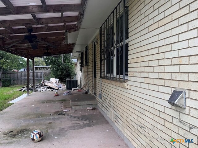 view of property exterior with central AC unit, ceiling fan, and a patio area