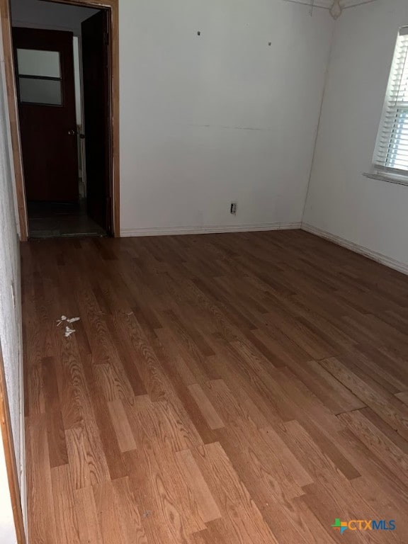 empty room featuring hardwood / wood-style flooring