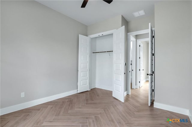 unfurnished bedroom with baseboards, ceiling fan, and a closet