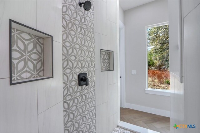 full bathroom featuring baseboards and walk in shower