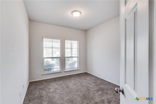 9019 Stonehollow Rd, Temple, TX 76502 - spare room with dark colored carpet and baseboards