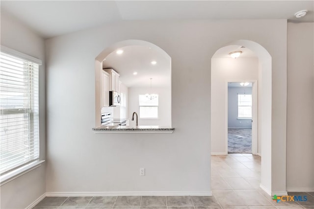9019 Stonehollow Rd, Temple, TX 76502 - spare room featuring a smoke detector, a sink, baseboards, and light tile patterned flooring