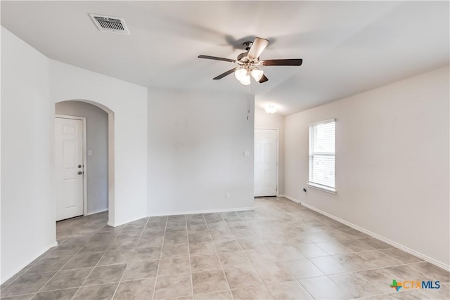 9019 Stonehollow Rd, Temple, TX 76502 - unfurnished room featuring arched walkways, ceiling fan, light tile patterned floors, vaulted ceiling, and baseboards