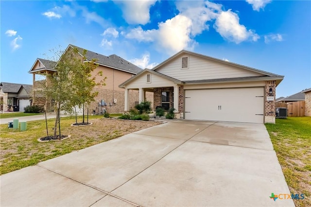 view of front of house featuring central air condition unit, a front yard, and a garage