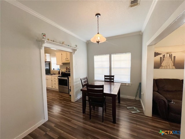 dining room with ornamental molding and dark hardwood / wood-style flooring