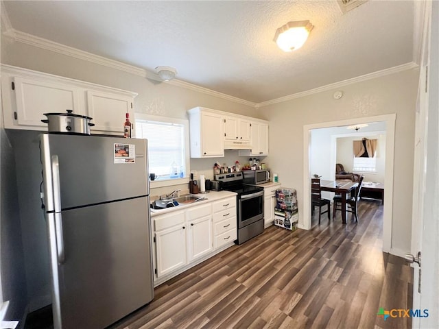 kitchen with white cabinetry, sink, crown molding, and stainless steel appliances