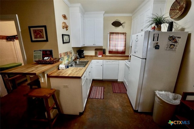 kitchen featuring a sink, white appliances, a peninsula, crown molding, and wooden counters