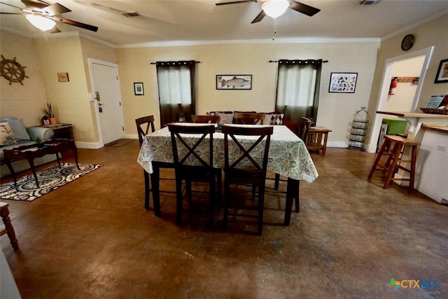 dining area featuring finished concrete floors, visible vents, crown molding, and a ceiling fan