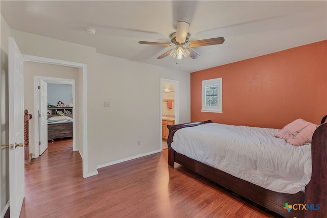 bedroom featuring ensuite bath, wood-type flooring, and ceiling fan