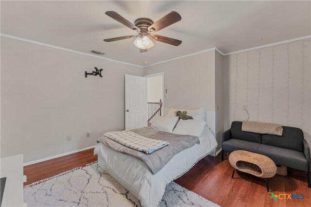 bedroom with light hardwood / wood-style flooring, ceiling fan, and crown molding