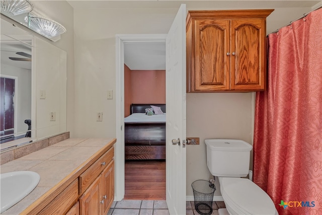 bathroom featuring toilet, vanity, and tile patterned floors