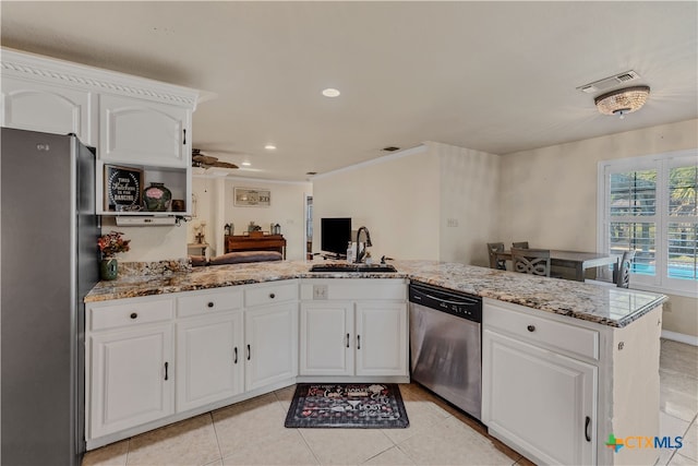 kitchen featuring stainless steel appliances, white cabinets, and kitchen peninsula