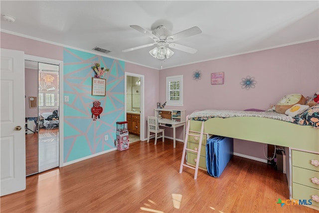 bedroom with hardwood / wood-style floors, ceiling fan, and crown molding