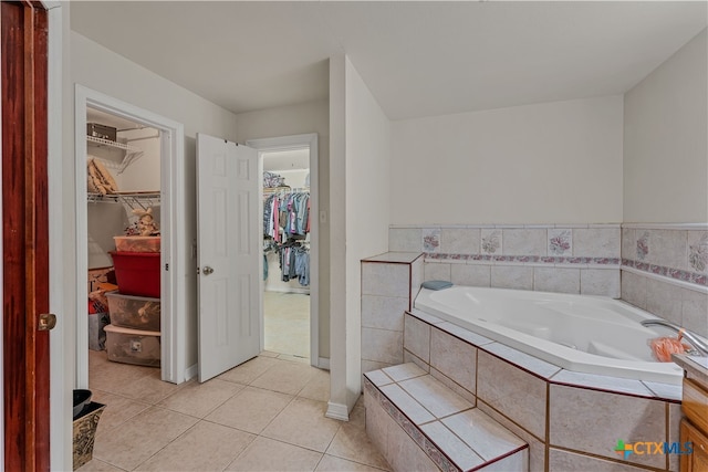 bathroom featuring tile patterned floors and a relaxing tiled tub