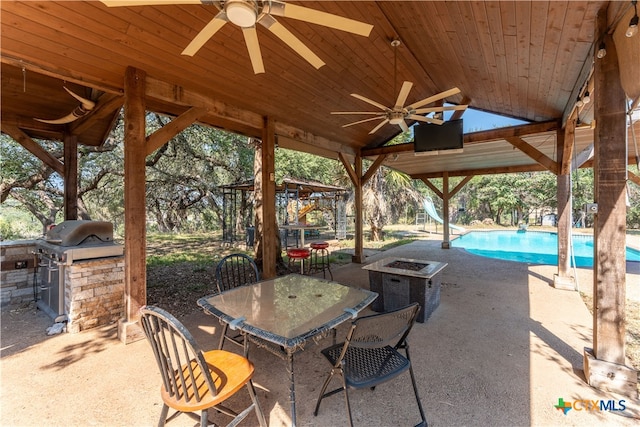 view of patio / terrace with a grill, area for grilling, and ceiling fan