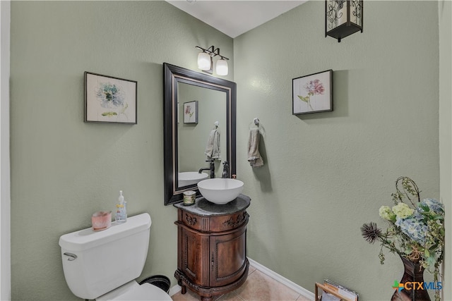 bathroom with vanity, tile patterned flooring, and toilet