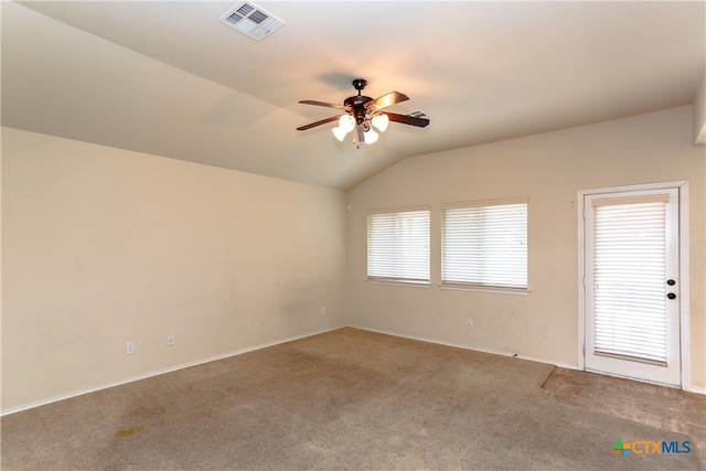 carpeted spare room with ceiling fan and vaulted ceiling