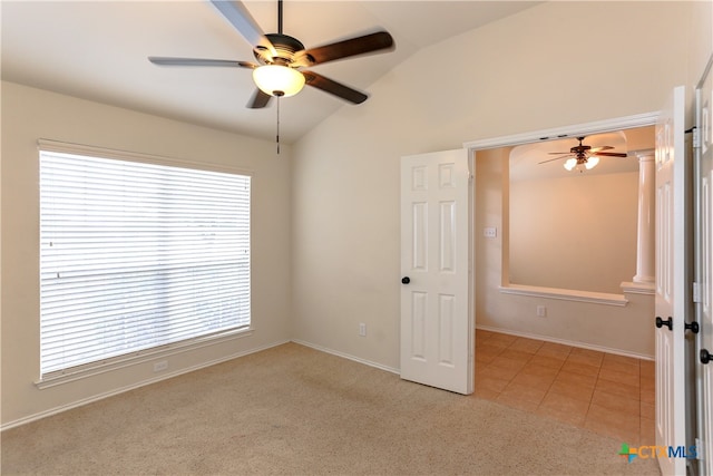 carpeted empty room featuring ceiling fan and lofted ceiling