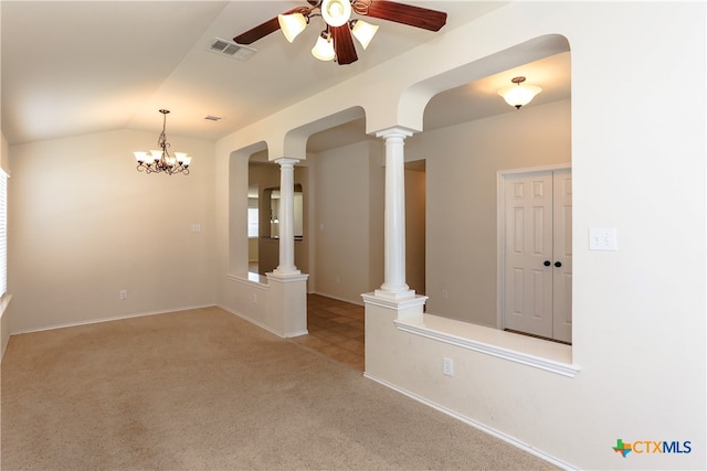 unfurnished room featuring vaulted ceiling, light colored carpet, ornate columns, and ceiling fan with notable chandelier