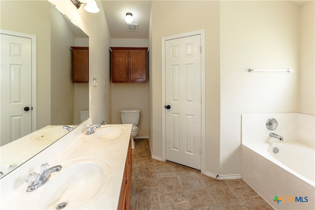 bathroom with a bathing tub, vanity, and toilet