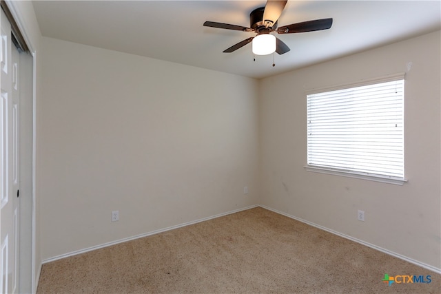 carpeted empty room with ceiling fan