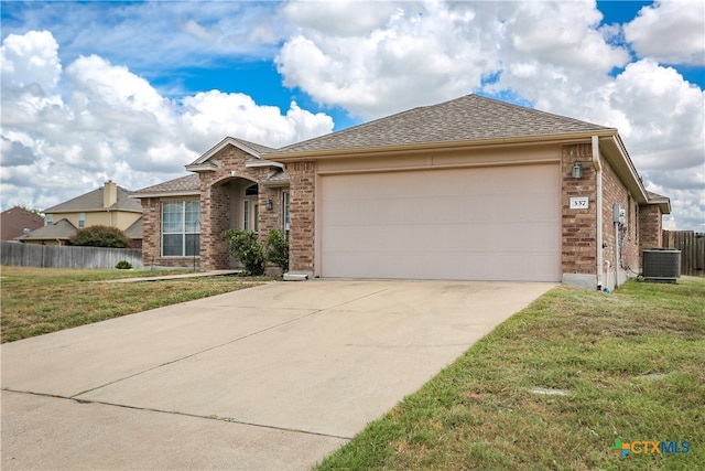 ranch-style house featuring a garage, a front yard, and central AC