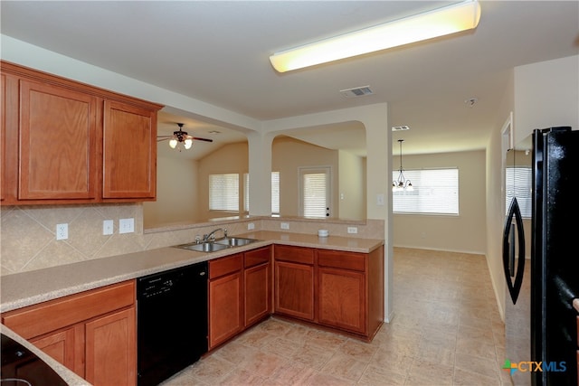 kitchen with black appliances, backsplash, sink, lofted ceiling, and ceiling fan with notable chandelier