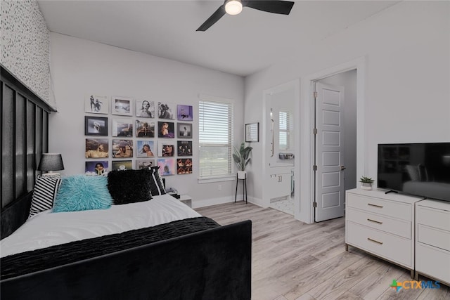 bedroom with light hardwood / wood-style floors, ceiling fan, and connected bathroom