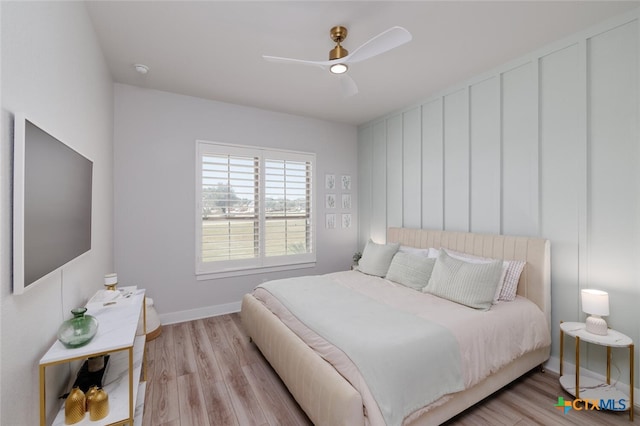 bedroom with light hardwood / wood-style flooring and ceiling fan