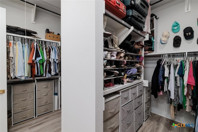 spacious closet featuring hardwood / wood-style flooring