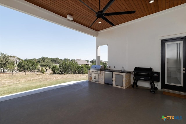 view of patio / terrace featuring an outdoor kitchen, ceiling fan, and a grill