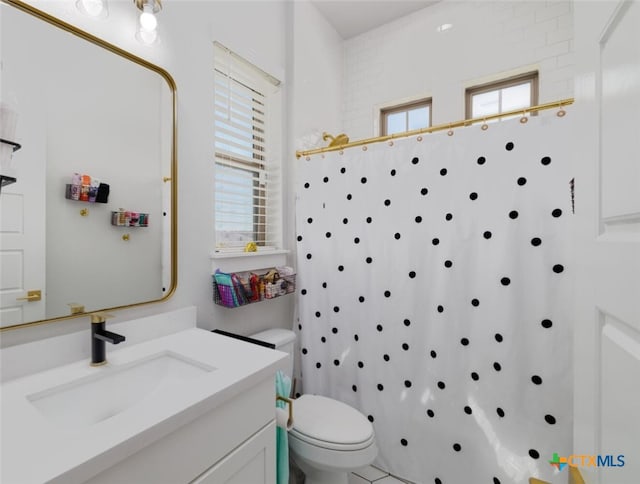 bathroom featuring toilet, a shower with curtain, and vanity