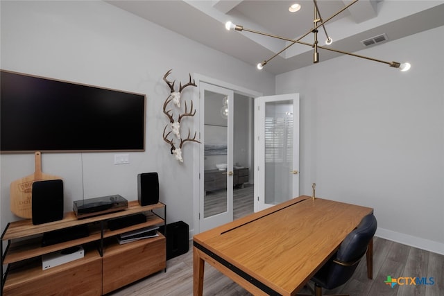 office area featuring a chandelier and hardwood / wood-style floors