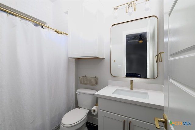 bathroom with toilet and vanity