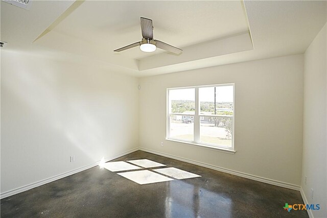 spare room featuring a raised ceiling