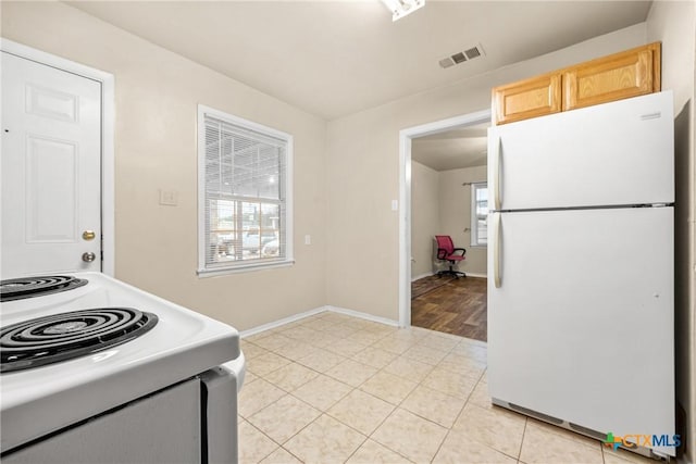 804 Little St, Copperas Cove, TX 76522 - kitchen with white appliances, light brown cabinetry, and light tile patterned floors