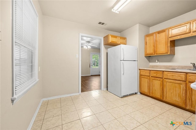 804 Little St, Copperas Cove, TX 76522 - kitchen with freestanding refrigerator, light countertops, a ceiling fan, and light tile patterned floors