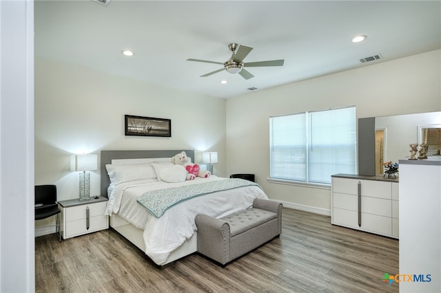 bedroom with hardwood / wood-style flooring and ceiling fan