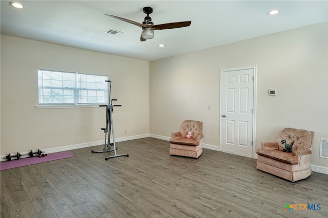 workout area featuring ceiling fan and light hardwood / wood-style floors