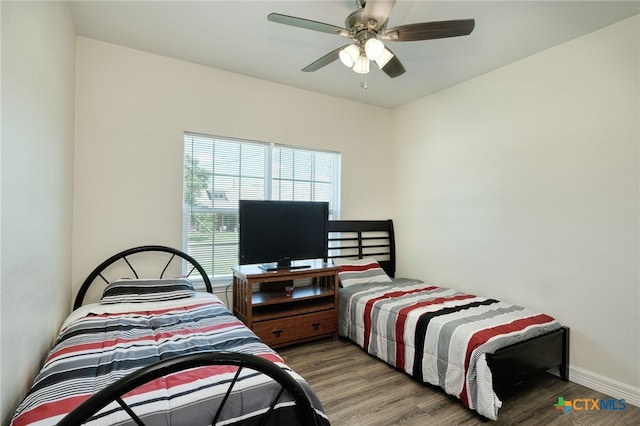 bedroom with wood-type flooring and ceiling fan