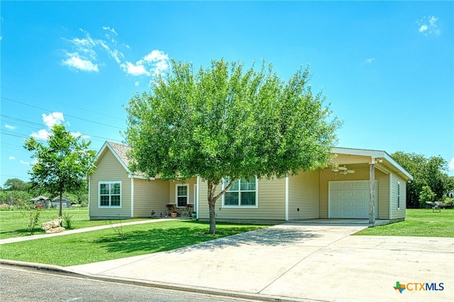 obstructed view of property with a garage and a front lawn