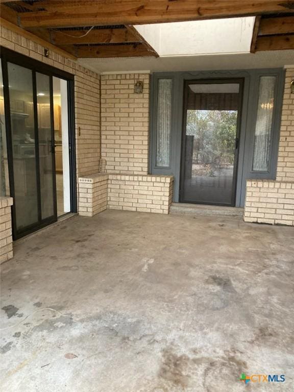 property entrance with brick siding