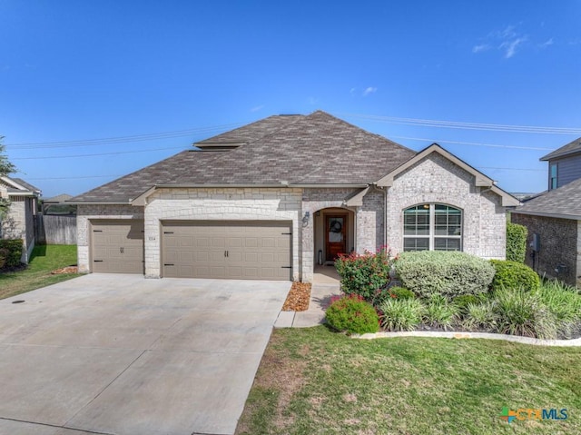 3214 Roan St, New Braunfels, TX 78130 - french country style house with an attached garage, concrete driveway, a shingled roof, brick siding, and a front yard